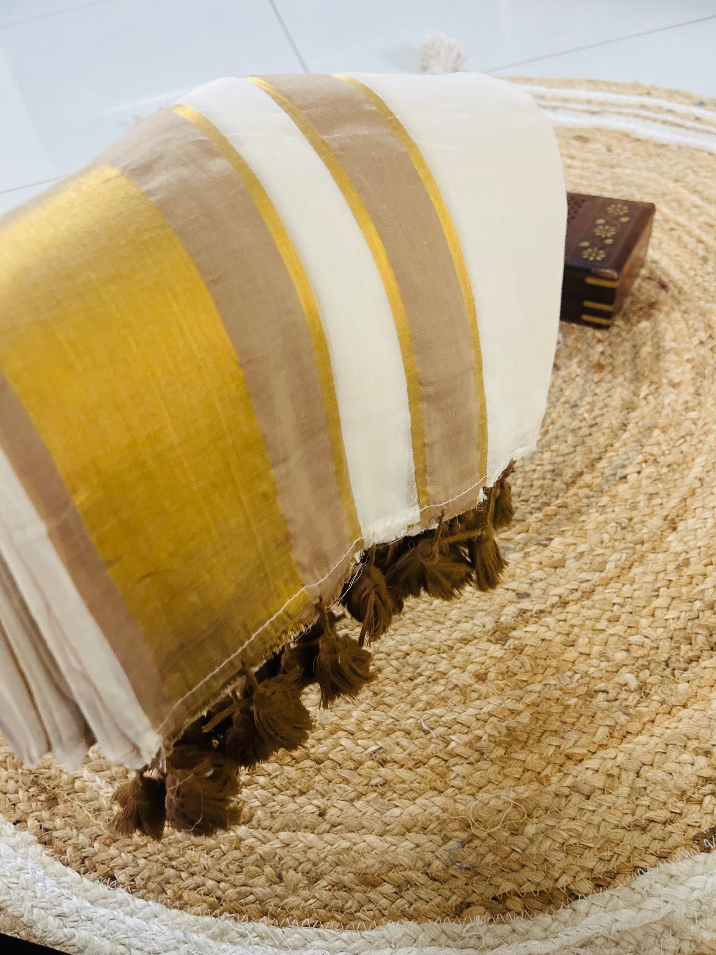 Pure and authentic mul cotton saree with light brown zari border and matching tassels