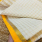 Pure and authentic mul cotton saree with zari checks all over and small mango yellow zari border