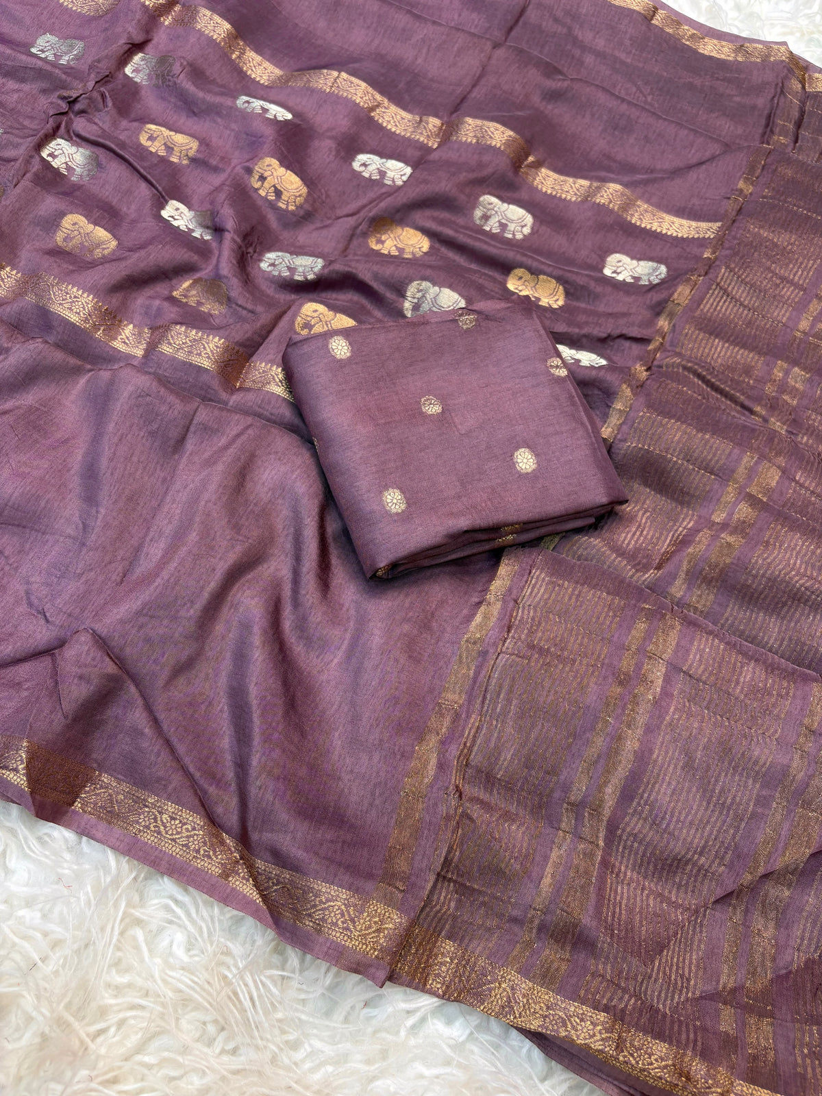 Soft viscous dola silk with beautiful silver and gold elephant motifs in the middle
