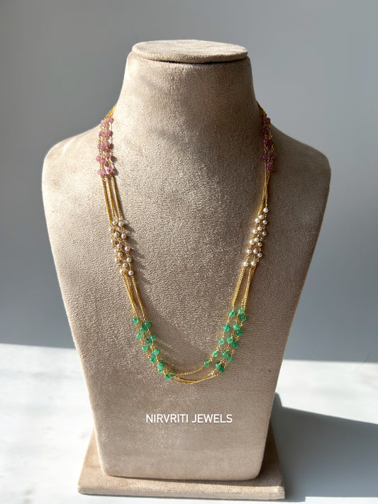 Elegant multi-strand necklace adorned with green beads, pearls, and pink accents for a graceful ethnic charm.