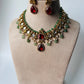 A stunning regal choker set adorned with ruby red stones, pearls, and emerald accents.