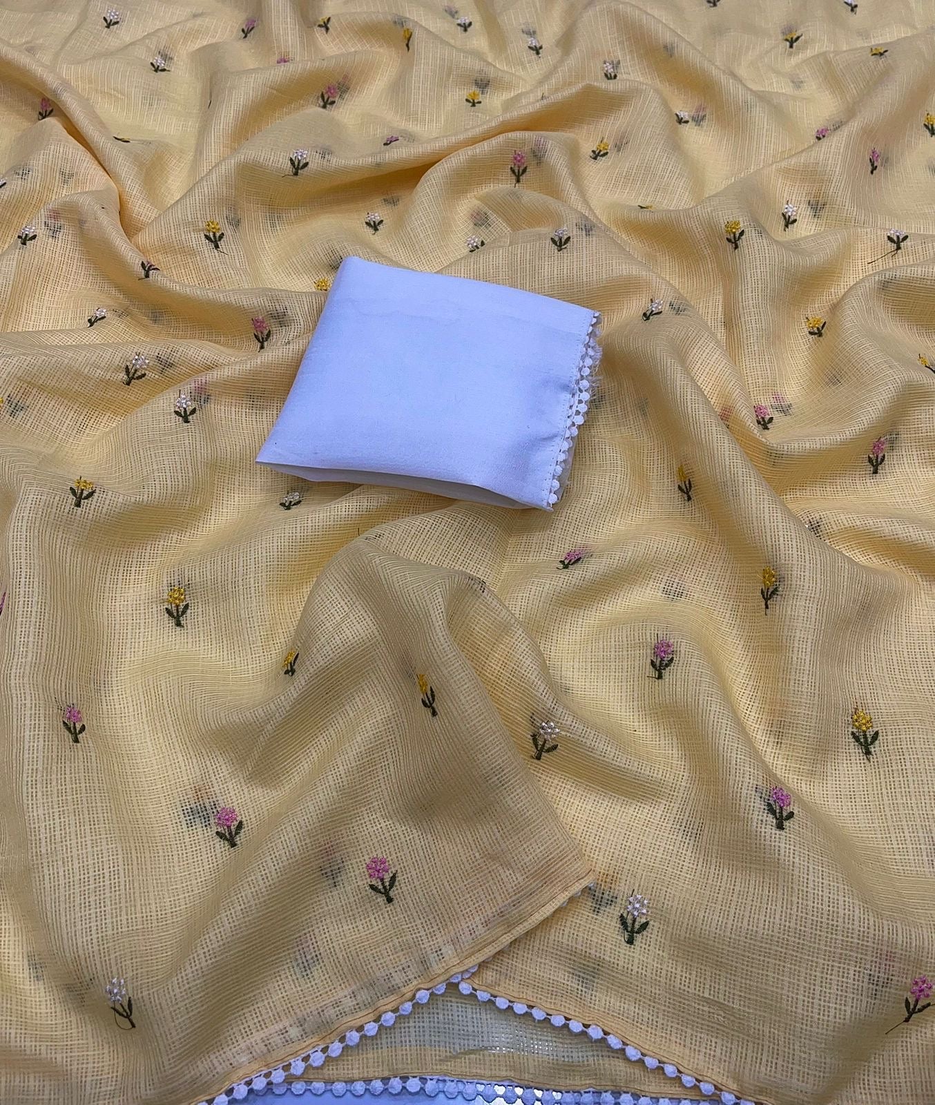 Soft kota saree with small floral butta embroidered body and lace border..