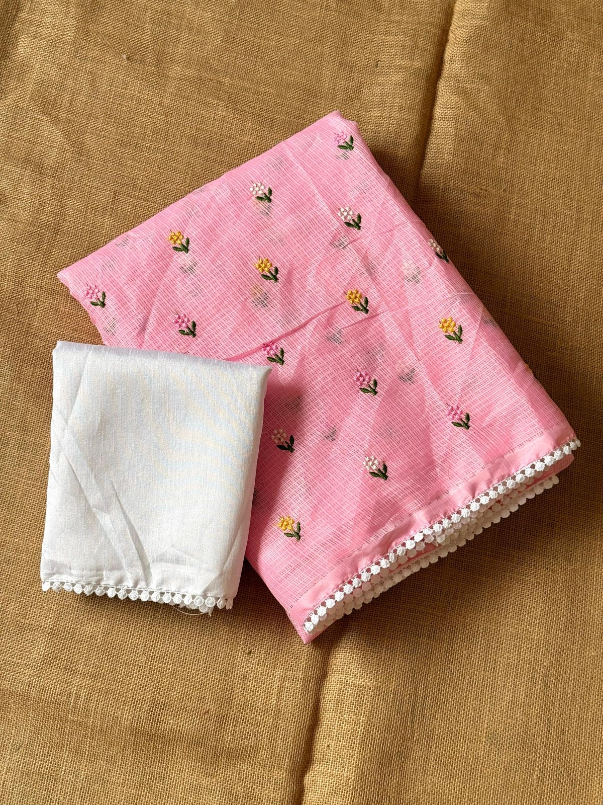 Soft kota saree with small floral butta embroidered body and lace border..