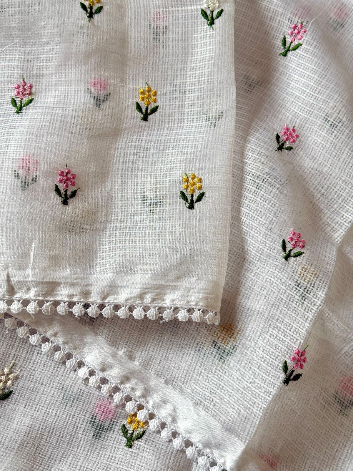 Soft kota saree with small floral butta embroidered body and lace border..