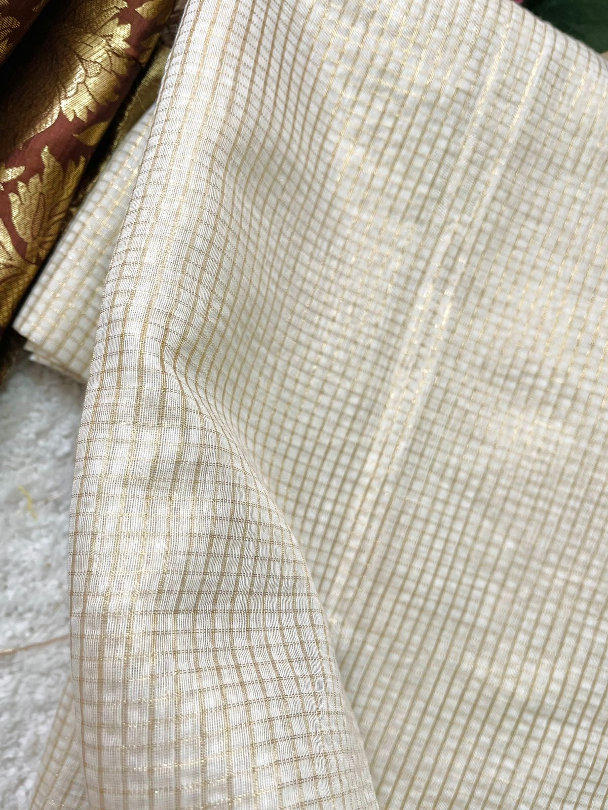 Beautiful semi chanderi silk saree with gold zari checks paired with brown Banarasi brocade blouse