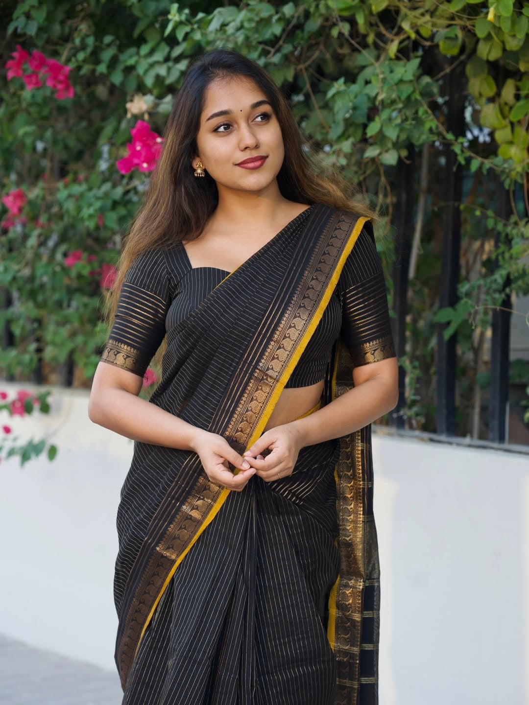Beautiful black pure kanchi cotton saree with zari stripes and small mango border