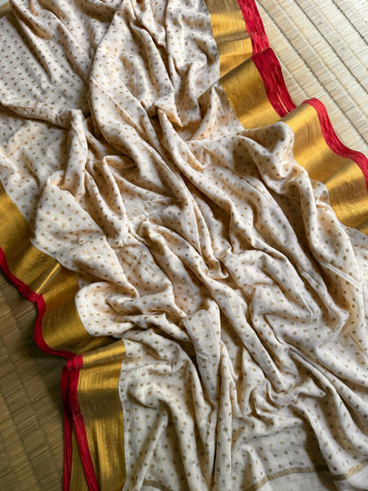 Pure authentic Mul Cotton saree adorned with delicate gold polka dots and a rich zari border for timeless festive elegance.