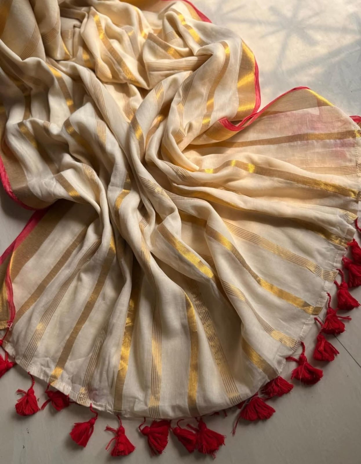 Beautiful pure authentic mul cotton saree with zari stripes and red border