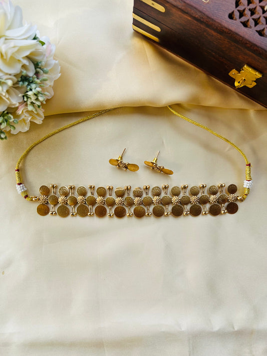 Coin choker with antique gold-finished coins and intricate floral motifs