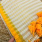 Pure and authentic mul cotton saree with zari checks all over and small mango yellow zari border