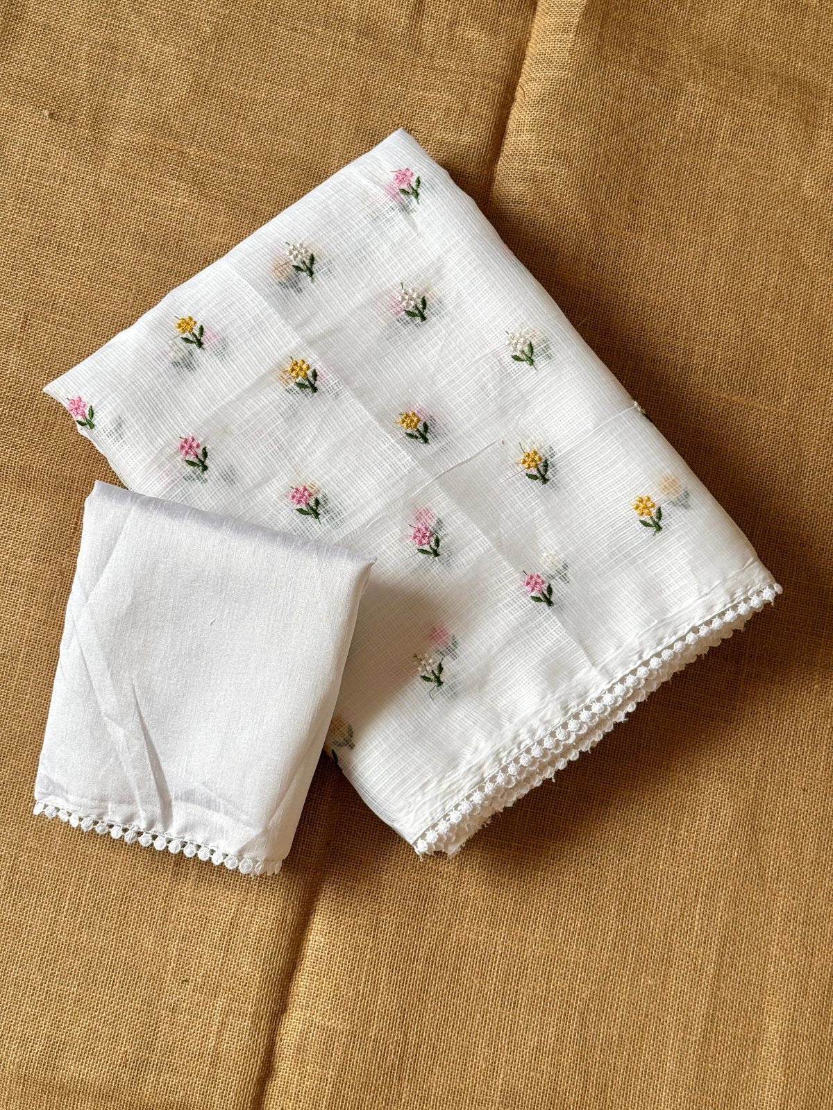Soft kota saree with small floral butta embroidered body and lace border..