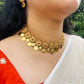 Traditional floral coin necklace set featuring vibrant red stones and an antique gold finish.